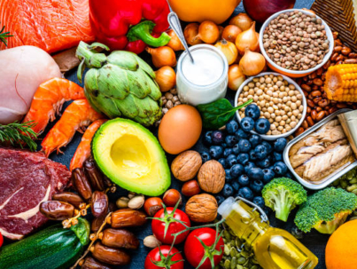 Overhead view of a large group of healthy raw food for flexitarian mediterranean diet. The composition includes salmon, chicken breast, canned tuna, cow steak,  fruits, vegetables, nuts, seeds, dairi products, olive oil, eggs and legumes. High resolution 42Mp studio digital capture taken with SONY A7rII and Zeiss Batis 40mm F2.0 CF lens