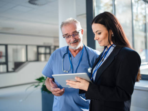 Young pharmaceutic seller explaining something to doctor in a hospital.