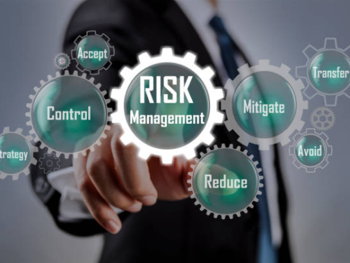Businessman pointing at risk management concept on screen
